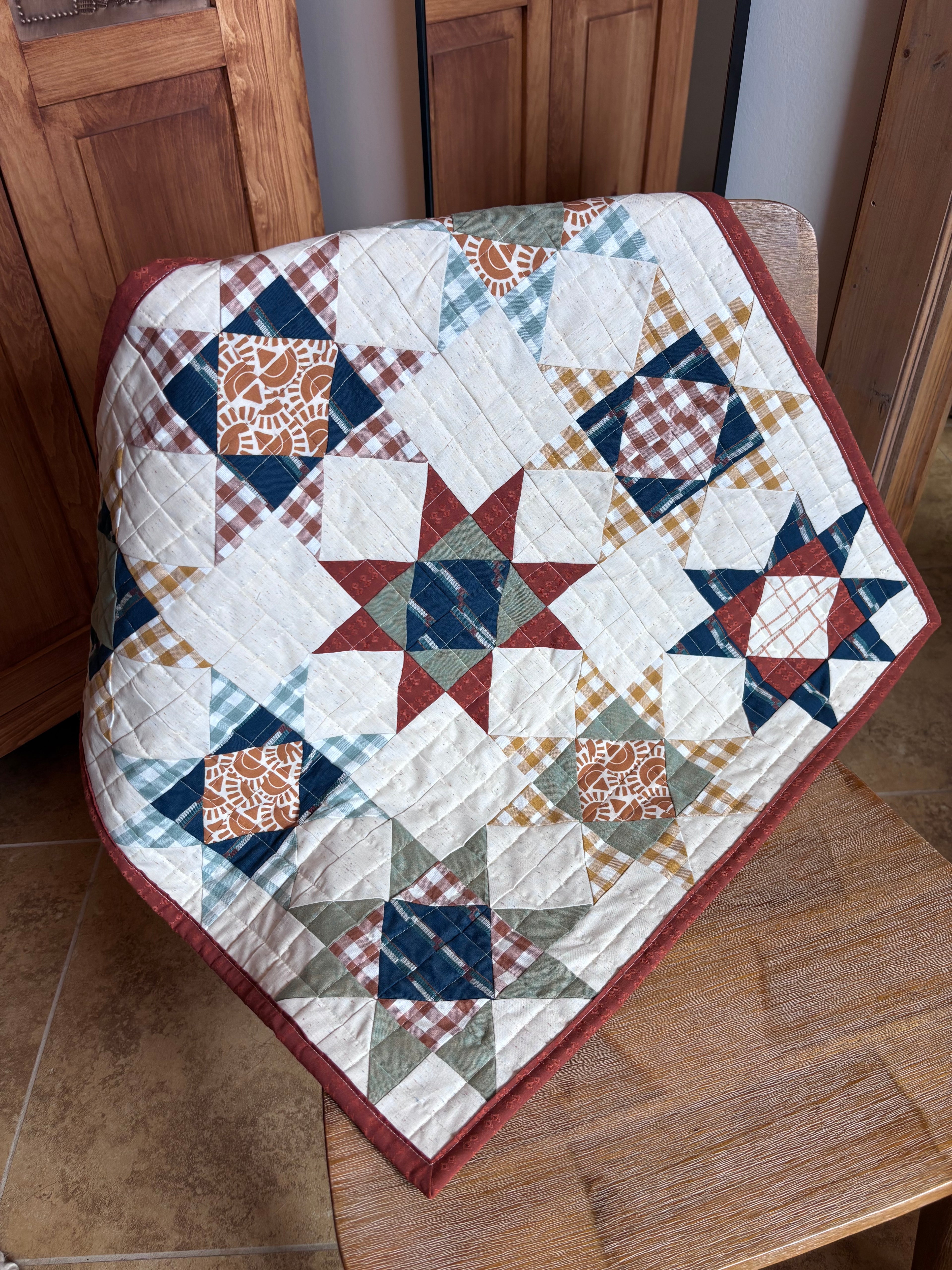Quilt with star pattern on a wooden chair